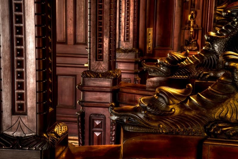 Intricate wooden details and ornate carvings of a historic chamber.